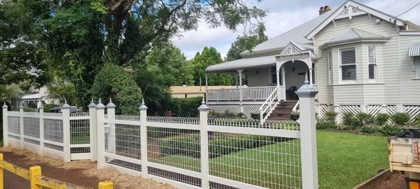 Tubular and picket front fence along a footpath