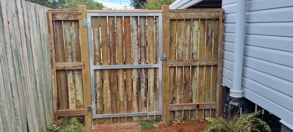 Timber feature gate beside a house