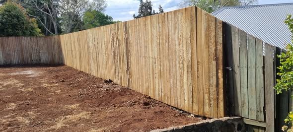 Long timber paling fence run